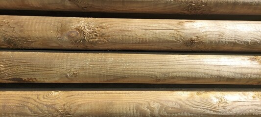 Backgrounds and textures - wooden round beams of brown color. Place for an inscription.