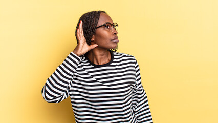 afro black pretty woman looking serious and curious, listening, trying to hear a secret...