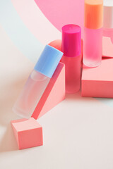 several bottles of perfume of different colors on a bright colorful background