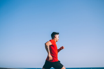 Young sportsman running in open air
