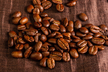 Natural background for Cafe menu or brochure template - macro photo of brown roasted coffee beans, close up