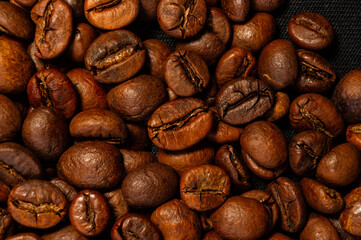 Natural background for Cafe menu or brochure template - macro photo of brown roasted coffee beans, close up