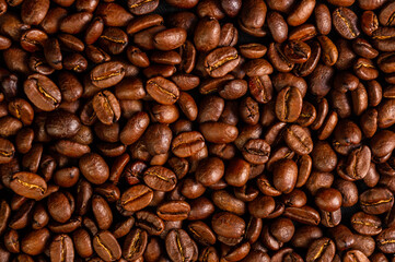 Natural background for Cafe menu or brochure template - macro photo of brown roasted coffee beans, close up