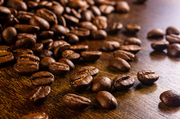 Natural background for Cafe menu or brochure template - macro photo of brown roasted coffee beans, close up