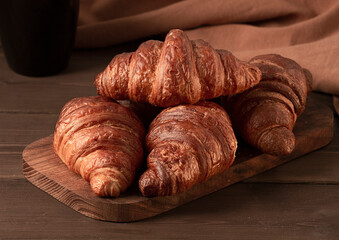 Pastries,Croissants on a brown wooden table, breakfast, no people, rustic style, top view, 