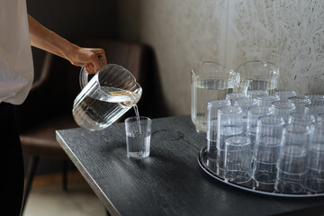 Woman filling glass with water