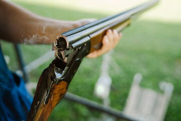 Mid Adult Man Training His Aim and Concentration Using a Shotgun in a Clay Pigeon Shooting Field Sport Centre 