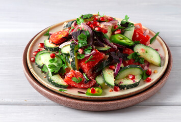 Traditional Georgian salad, Fresh vegetables, with walnut dressing, spices, herbs, pomegranate seeds, horizontal, no people,