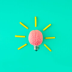Brain bulb. A glowing brain. Minimal composition of an educational character on a blue background. Idea, Thinking, Progress, Flowering, Working on yourself, Psychology.