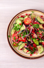 Traditional Georgian salad, Fresh vegetables, with walnut dressing, spices, herbs, pomegranate seeds, horizontal, no people,