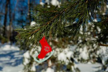 Christmas pendant toy figure skates hanging on a Christmas tree branch