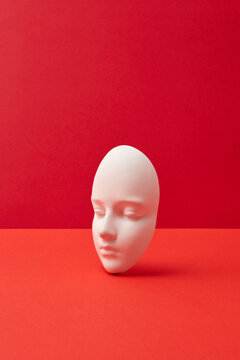 Plaster mask on red