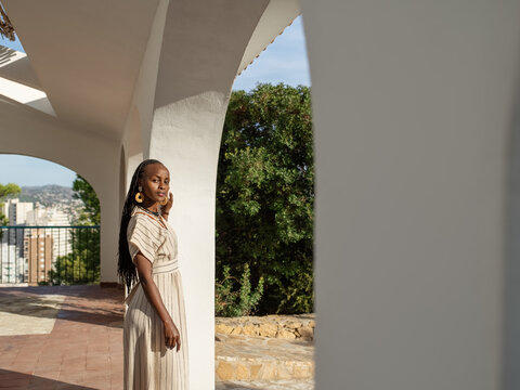Black woman resting on arched terrace
