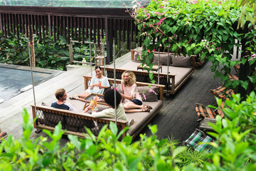 Friends relaxing by the pool in the resort
