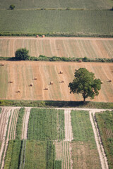 top view of a cultivated field and hay bales in Tuscany