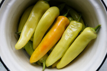 Fresh white bitter peppers in the pot, close-up