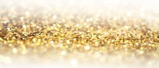 Blur Gold (bronze) glitter shine dots confetti. Abstract light blink sparkle defocus backgound.