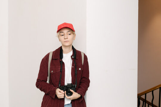 portrait of young non binary person holding camera