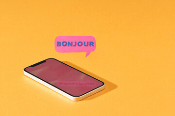 Cell phone with Bonjour in speech bubble