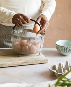 Home cook preparing eggs in steamer basket