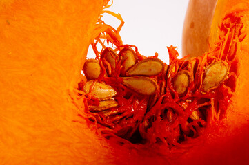 Sliced fresh orange large pumpkin with seeds, close-up. Organic agricultural product, cooking...