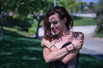 Young Hispanic and transgender girl hugging herself, proud, happy and loving. Concept of...