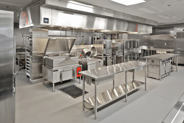 Interior of modern restaurant cafeteria hotel kitchen with stainless steel appliances - Powered by Adobe