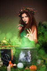 A witch with disheveled hair and long nails with a wreath of dry branches on her head, dressed in a...