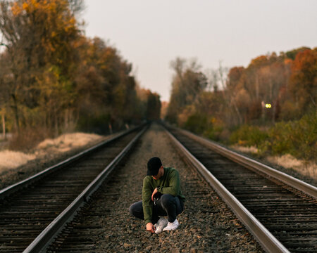 Young Man on Railroad Train Tracks