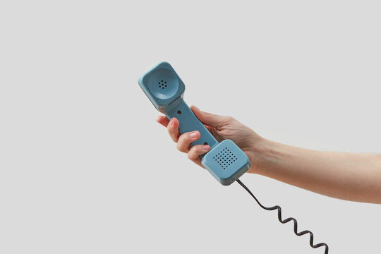 Woman holding blue telephone handset