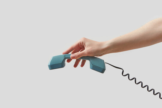 Woman holding stylish blue telephone handset