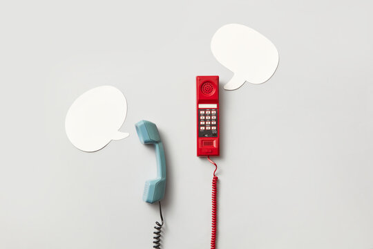 Telephone handsets and speech bubbles