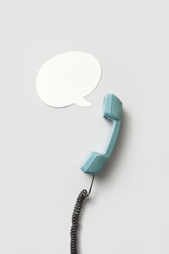 Blue telephone handset and speech bubble