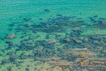 Crystal clear turquoise water surrounded by cliffs