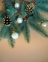 Christmas background with fir branches, small balls and cones. top view
