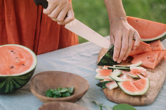 Anonymous Woman Slicing Watermelon For Vegan Appetizer 