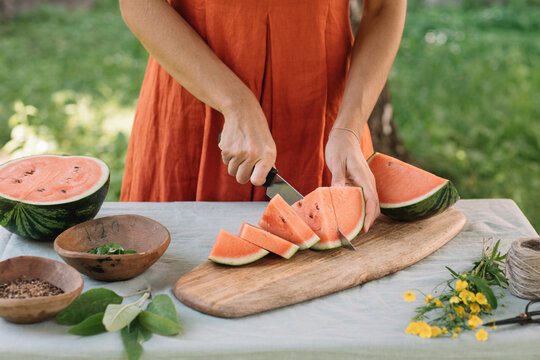 Anonymous Woman Slicing Watermelon For Vegan Appetizer 