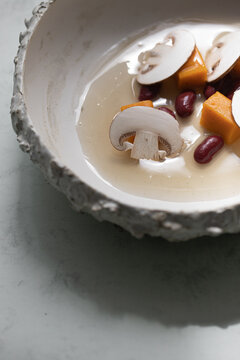 Food: Consome of Ceps, pumpkin gnochi and black beans