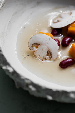 Food: Consome of Ceps, pumpkin gnochi and black beans