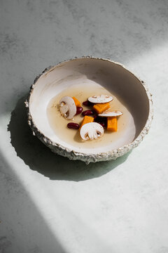 Food: Consome of Ceps, pumpkin gnochi and black beans