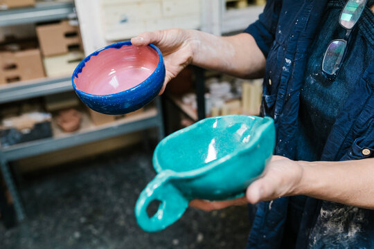 Crop craftsman demonstrating handmade glazed ceramics