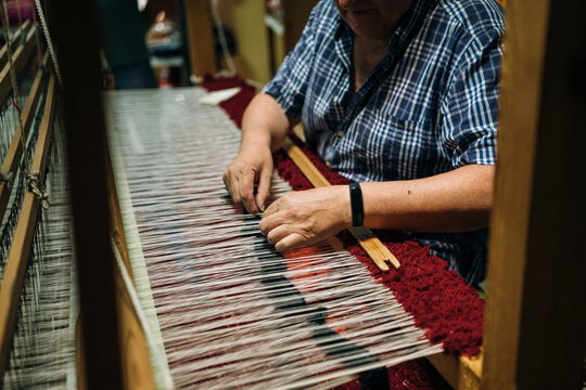 Craftsman Hands Working over the Warp