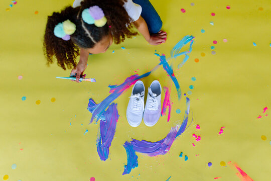 Overhead shot of girl painting on floor
