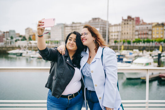 Two plus size girls take a selfie in the city