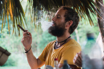Bearded man smoking cigar