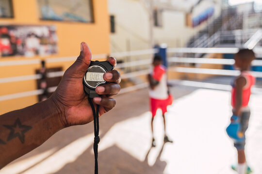 Person with timer and teenagers on ring