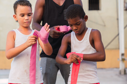 Young boxers putting on bandages for fighting.