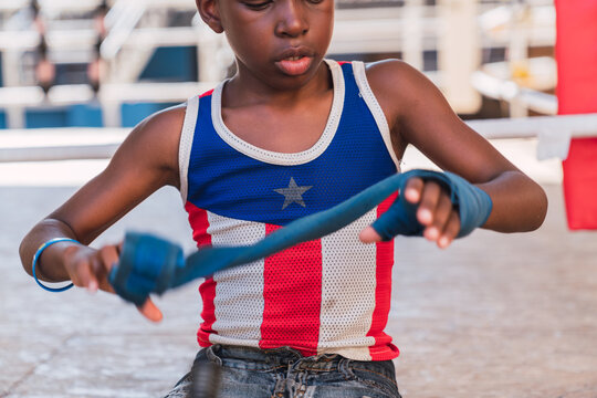 Young boxer putting on bandages for boxing.