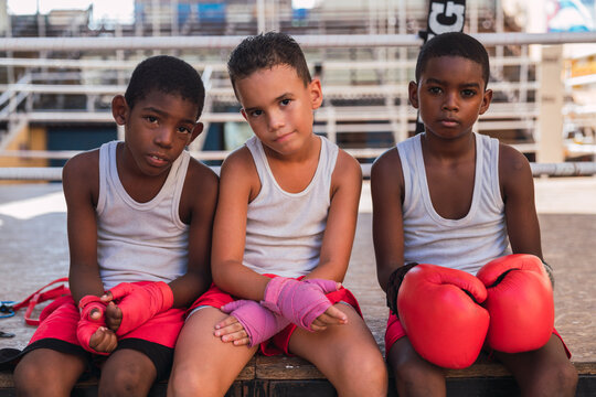 Young boys with boxing gloves on.