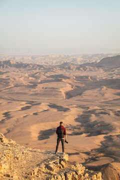 Man standing on top of a cliff. 